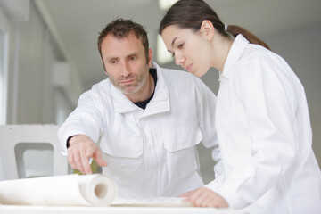 female apprentice training to use wallpaper