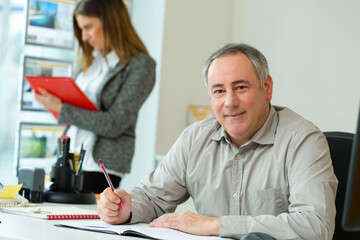 portrait of happy businessman with computer