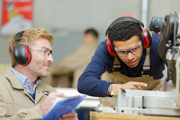 young factory worker supervised by trainer