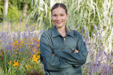 Fototapeta premium young happy woman working in her greenhouse