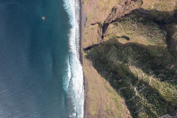Great drone photo on a sunny day at the cliff of the Portigian island of Madeira.