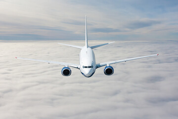 A passenger airliner fly above the clouds
