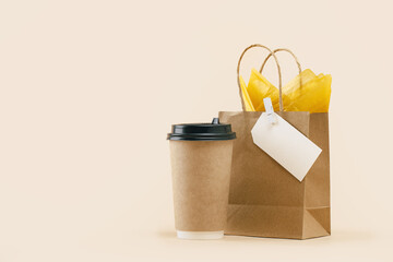 Takeaway paper coffee cup with lunch bag and burger box on beige. Snack delivery service. Coffee to...