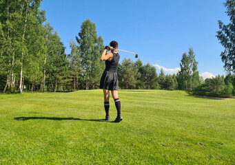 Rear view of golfer woman after golf piggyback