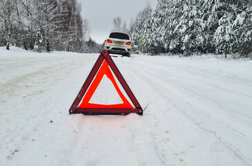 Emergency red sign on a snowy road concept