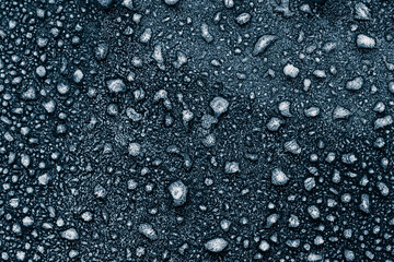 Frosty surface with ice crystals. Ice texture crystals on black background. The textured cold frozen surface. Macro photo.