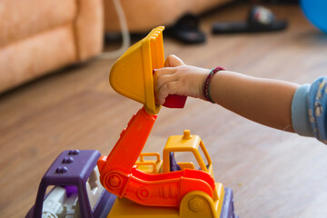 Kid's hand holding a toy car close-up