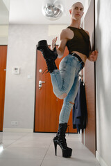Muscular fluid gender man in black high heels . High quality photo