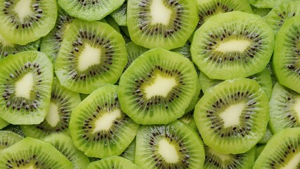 Heap of Sliced kiwi fruits top view. Fresh and healthy food concept