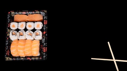 Overhead shot of Japanese sushi on black concrete background