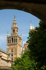 The Giralda tower in Seville, seen through the arch of the castle entrance.