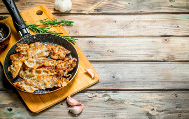 Fried bacon with garlic and spices.