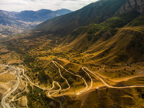 Winding road in the Dagestan Mountains with big mountain formation in the background. Russia