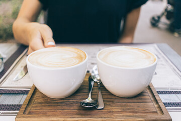 woman holding hands two cups of coffee