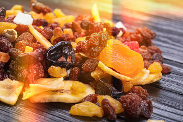 wooden background in retro style. a mixture of dried fruits lies on it. close-up. there is a...