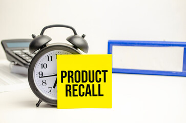 Product Recall yellow card with alarm clock and calculator