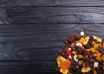 wooden background in retro style. a mixture of dried fruits lies on it. close-up. there is a...