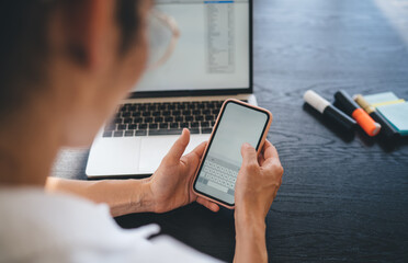 Crop freelancer using mobile at workplace