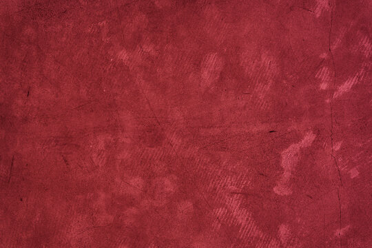 The surface of old concrete with stains. The color of 2023, viva magenta red with space to copy. High quality photo
