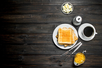 Breakfast. Toasted bread with butter and aromatic coffee.