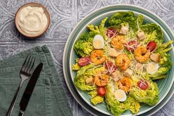 Food photography of caesar salad, prawn, shrimp, romaine, lettuce, quail, egg,  parmesan, croutons, sauce