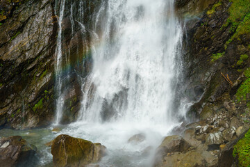 Detail of the waterfall Stuibenfall with a rainbow in Ötztal in Tyrol, Austria