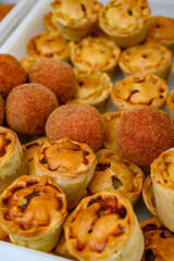 Traditional street food in UK, stuffed fried Scotch eggs with breadcrumbs and baked pie with pork meat
