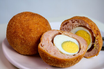 Traditional street food in UK, stuffed fried Scotch eggs with breadcrumbs