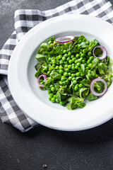 green pea salad green lettuce mix fast food healthy meal food snack on the table copy space food background rustic top view keto or paleo diet veggie vegan or vegetarian food