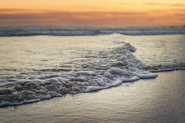 sea waves with an incredible sunset. the concept of loneliness. clean sea sand and ocean waves