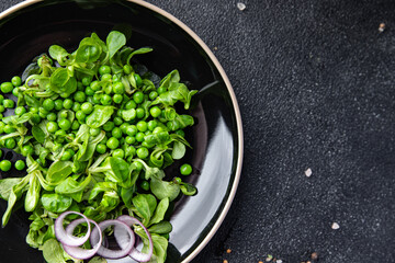 green pea salad green lettuce mix fast food healthy meal food snack on the table copy space food background rustic top view keto or paleo diet veggie vegan or vegetarian food