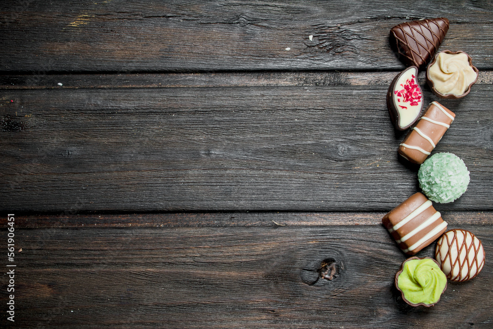 Wall mural Chocolate sweets with nuts and various fillings.