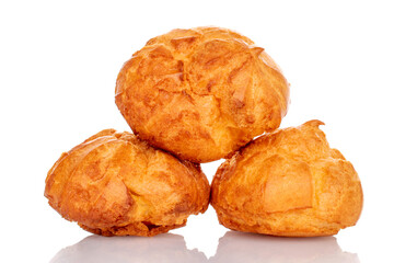 Several fresh fragrant chouquettes, on a white background.