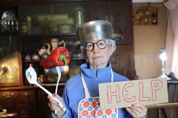 Senior woman asking for help in the kitchen  - obrazy, fototapety, plakaty