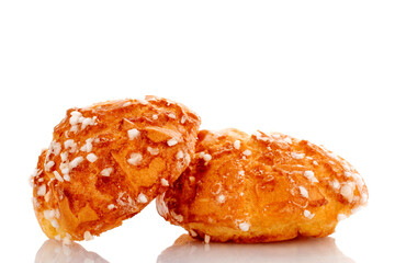 Two sweet chouquette, close-up, isolated on white.