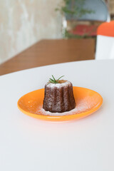 Caneles de bordeaux on plate,traditional French sweet dessert.