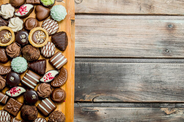 Chocolate sweets on a wooden Board.