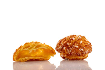 One half and one whole sweet chouquette, close-up, isolated on white.