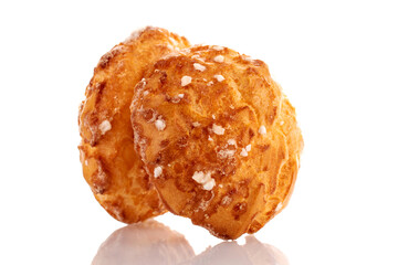 Two sweet chouquettes, close-up, isolated on white.