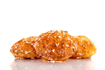 Three sweet chouquette, close-up, isolated on white.