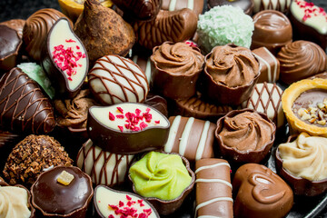 Chocolate candies with nuts and various fillings.