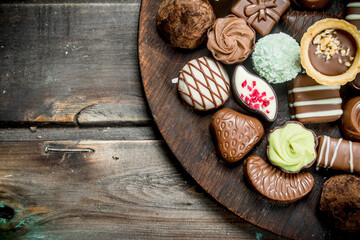 Chocolate sweets on a wooden Board.