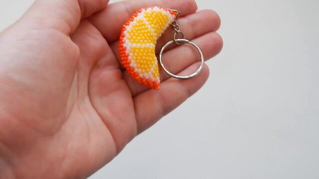 Fruit keychain in a female hand