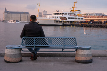 A Man On A Bench By The Sea.