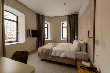 comfortable bed with pillows in modern hotel bedroom.