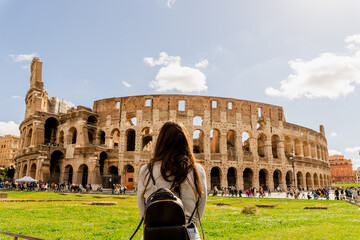 young woman in front of roman colosseum