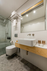 interior of modern bathroom with white clean glasses near sink.