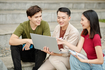 Group of happy students discussing presentation they created for class