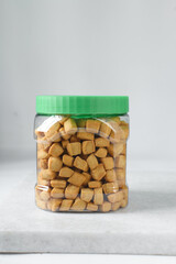 Nigerian Chin chin in a plastic jar, Fried chin-chin snack in a plastic jar, Nigerian party food and small chops