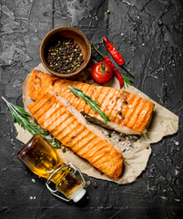 Grilled salmon fillet with rosemary branches.